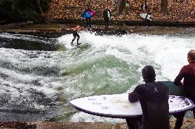 Surfers Brave The Icy Waters Of The Eisbach Stream In Munich In Autumn