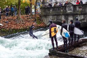 Surfers Brave The Icy Waters Of The Eisbach Stream In Munich In Autumn