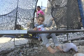 Children Entertain Amid Ruins - Gaza