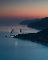 Gargano Coastline At Sunset With Fish Farming Activity