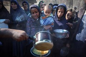 Gaza Children Wait To Receive A Hot Meal Of Food