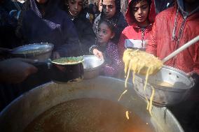 Gaza Children Wait To Receive A Hot Meal Of Food