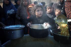 Gaza Children Wait To Receive A Hot Meal Of Food