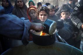 Gaza Children Wait To Receive A Hot Meal Of Food