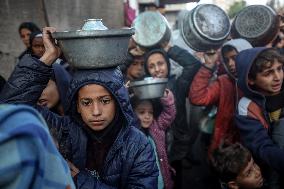 Gaza Children Wait To Receive A Hot Meal Of Food