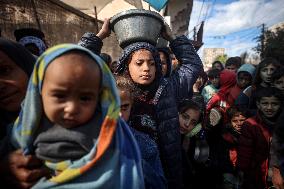 Gaza Children Wait To Receive A Hot Meal Of Food