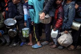 Gaza Children Wait To Receive A Hot Meal Of Food