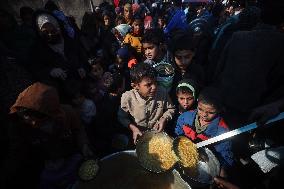 Gaza Children Wait To Receive A Hot Meal Of Food