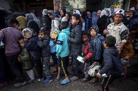 Gaza Children Wait To Receive A Hot Meal Of Food