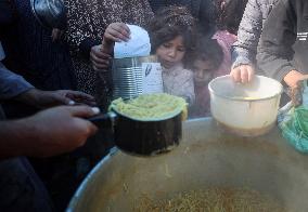 Gaza Children Wait To Receive A Hot Meal Of Food