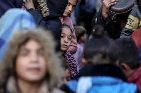 Gaza Children Wait To Receive A Hot Meal Of Food