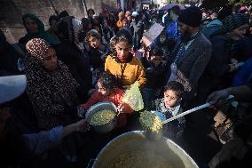 Gaza Children Wait To Receive A Hot Meal Of Food