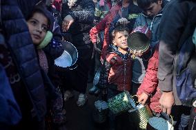 Gaza Children Wait To Receive A Hot Meal Of Food