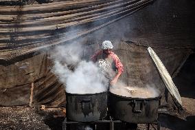 Gaza Children Wait To Receive A Hot Meal Of Food