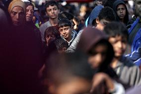 Gaza Children Wait To Receive A Hot Meal Of Food