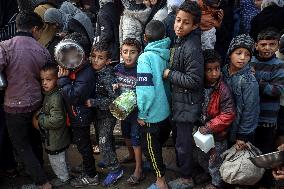 Gaza Children Wait To Receive A Hot Meal Of Food