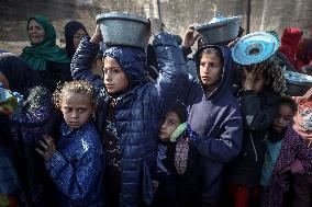 Gaza Children Wait To Receive A Hot Meal Of Food