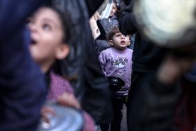 Gaza Children Wait To Receive A Hot Meal Of Food