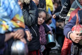 Gaza Children Wait To Receive A Hot Meal Of Food