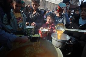 Gaza Children Wait To Receive A Hot Meal Of Food