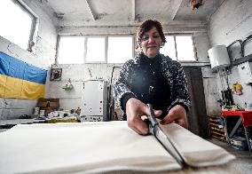 Volunteers weave winter camouflage nets for army in Zaporizhzhia