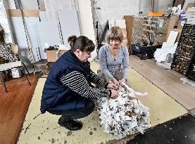 Volunteers weave winter camouflage nets for army in Zaporizhzhia