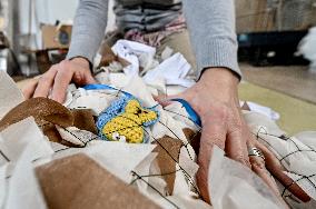 Volunteers weave winter camouflage nets for army in Zaporizhzhia