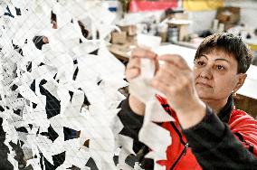 Volunteers weave winter camouflage nets for army in Zaporizhzhia