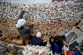 Volunteers weave winter camouflage nets for army in Zaporizhzhia