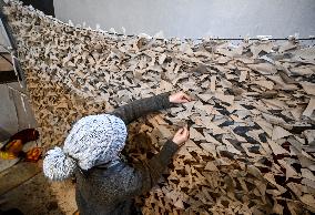 Volunteers weave winter camouflage nets for army in Zaporizhzhia