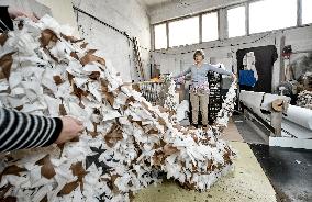 Volunteers weave winter camouflage nets for army in Zaporizhzhia