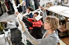 Volunteers weave winter camouflage nets for army in Zaporizhzhia