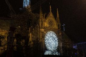 A Light Show Projected On The Facade Of Notre-Dame Cathedral - Paris