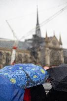 People attend the first mass outside Notre Dame Cathedral - Paris