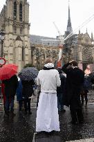 People attend the first mass outside Notre Dame Cathedral - Paris