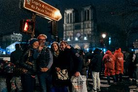 People attend the second mass outside Notre Dame Cathedral - Paris