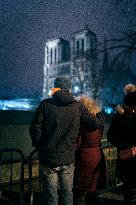 People attend the second mass outside Notre Dame Cathedral - Paris