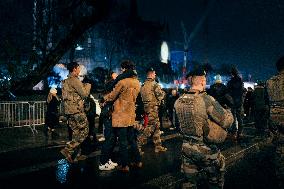 People attend the second mass outside Notre Dame Cathedral - Paris