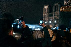 People attend the second mass outside Notre Dame Cathedral - Paris