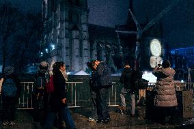 People attend the second mass outside Notre Dame Cathedral - Paris