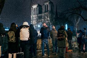 People attend the second mass outside Notre Dame Cathedral - Paris