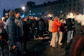 People attend the second mass outside Notre Dame Cathedral - Paris