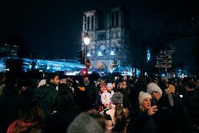 People attend the second mass outside Notre Dame Cathedral - Paris