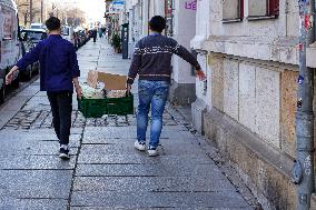 Asian Workers Transporting Goods In Dresden