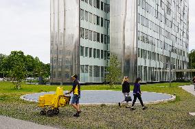 German Postman Passing A Skyscraper