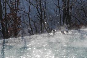 Tourists Enjoy An Outdoor Hot Spring - China