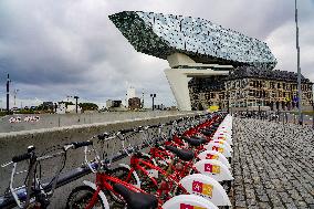 Velo Antwerp Bikes With Port House. An Iconic View Of Urban Sustainability