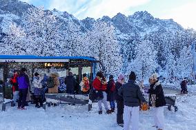 Winter Travelers In Bavaria At Lake Eibsee Bus Stop