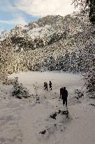 People Hiking Around The Bavarian Alpine Lake Eibsee In Winter