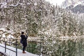 People Hiking Around The Bavarian Alpine Lake Eibsee In Winter